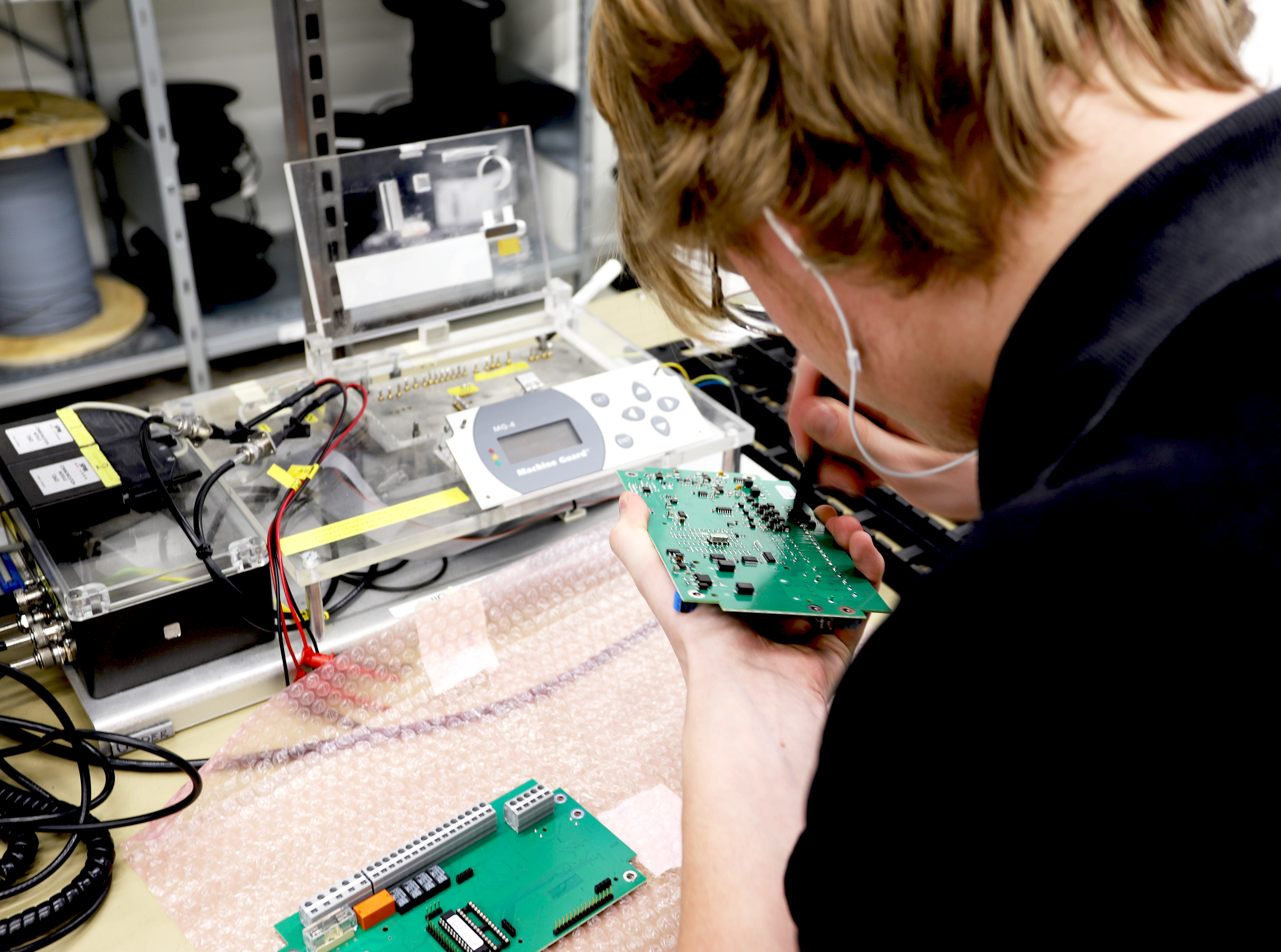 Electronics technician soldering on a circuit board Electronics technician soldering on a circuit board
